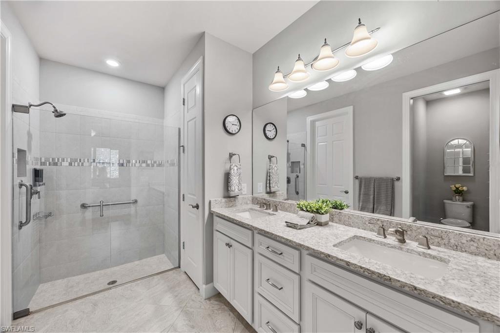 7658 Jacaranda Lane Naples, FL 34114 - Photo 12 of 30 Full bath with double vanity and a walk in tile shower, walk in primary closet , linen closet
