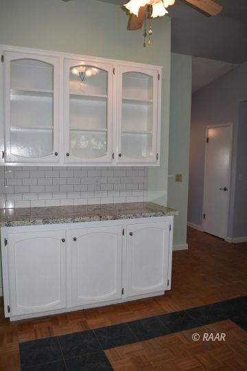 313 South Lilac Street Ridgecrest, CA 93555 - Photo 9 of 26 a view of cabinets and wooden floor