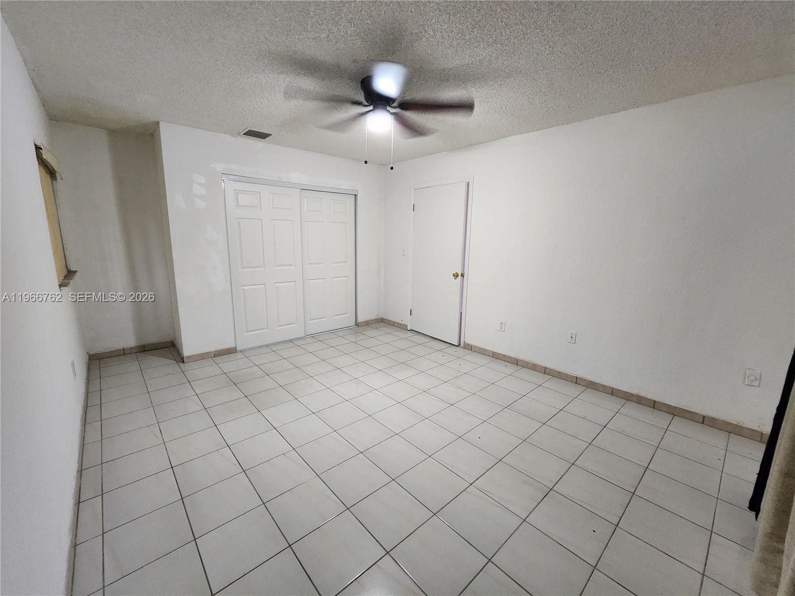 16311 Southwest 102nd Place, Unit A Miami, FL 33157 - Photo 12 of 15 a view of an empty room and window