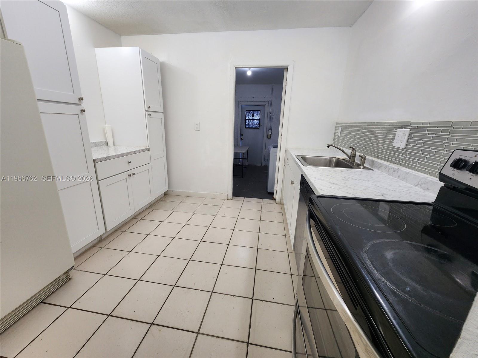 16311 Southwest 102nd Place, Unit A Miami, FL 33157 - Photo 2 of 15 a room with washing machine