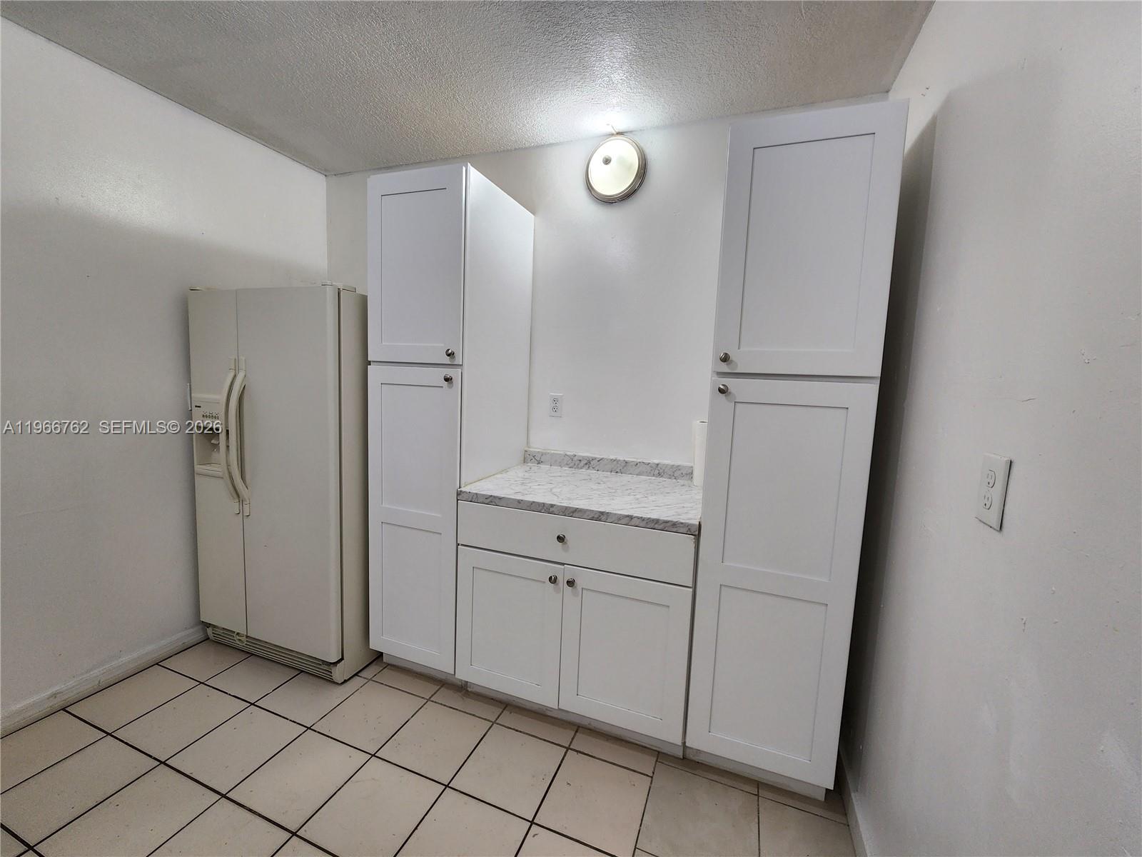 16311 Southwest 102nd Place, Unit A Miami, FL 33157 - Photo 4 of 15 a view of a kitchen with white cabinets