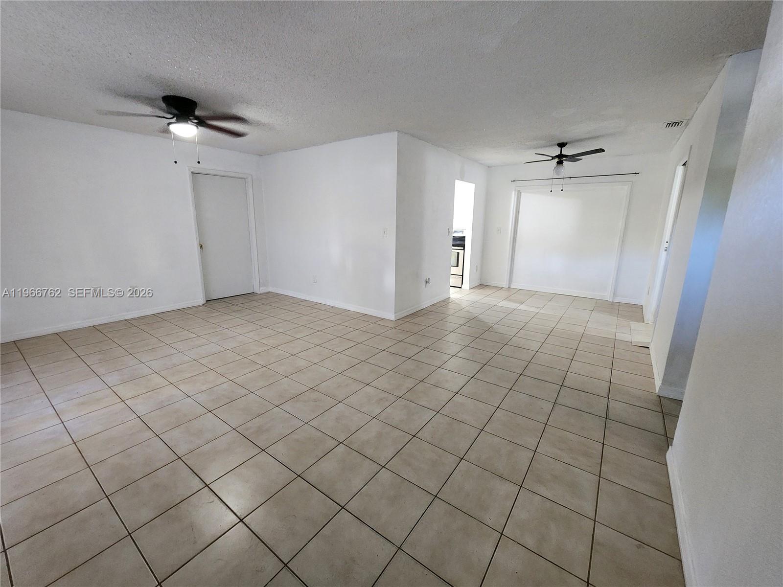 16311 Southwest 102nd Place, Unit A Miami, FL 33157 - Photo 7 of 15 an empty room & glass door