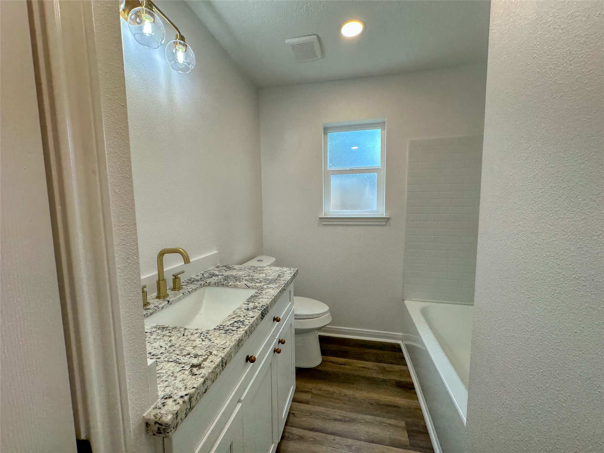 29310 Loddington Street Spring, TX 77386 - Photo 19 of 23 a bathroom with a granite countertop sink and a mirror