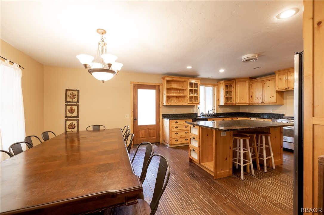 630 Summit Boulevard Big Bear Lake, CA 92315 - Photo 4 of 33 a kitchen with stainless steel appliances granite countertop a sink counter space and dining table