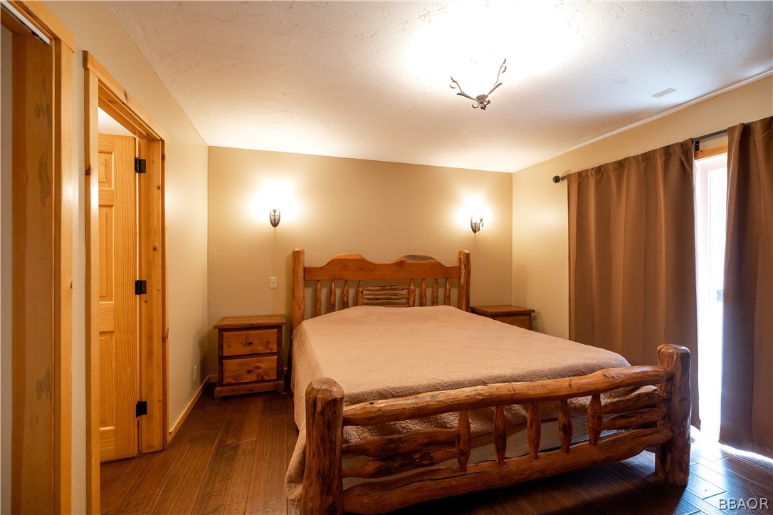 630 Summit Boulevard Big Bear Lake, CA 92315 - Photo 7 of 33 a bedroom with a bed and a chandelier