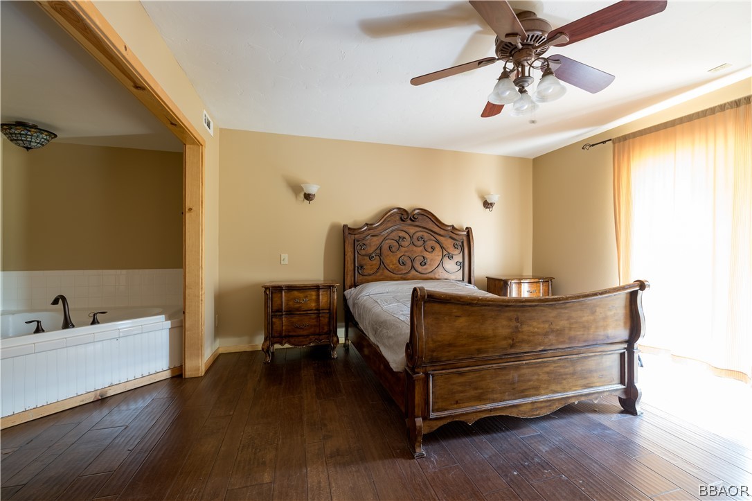 630 Summit Boulevard Big Bear Lake, CA 92315 - Photo 9 of 33 a bedroom with a bed and wooden floor