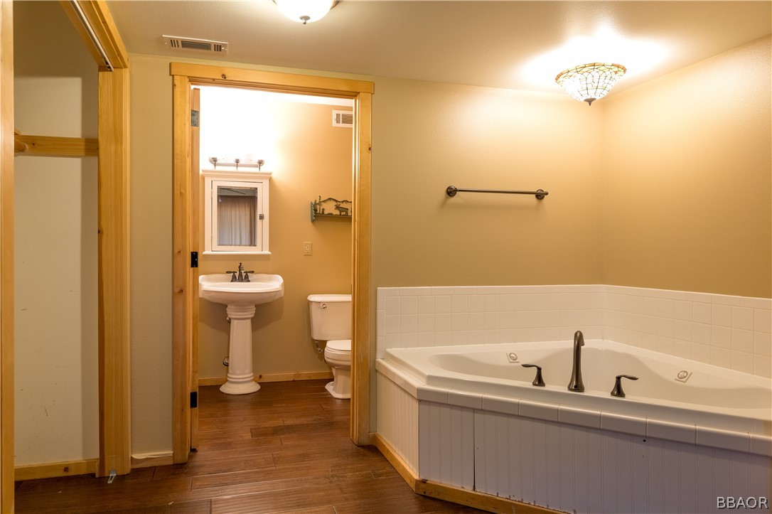 630 Summit Boulevard Big Bear Lake, CA 92315 - Photo 10 of 33 a bathroom with a sink a toilet and shower
