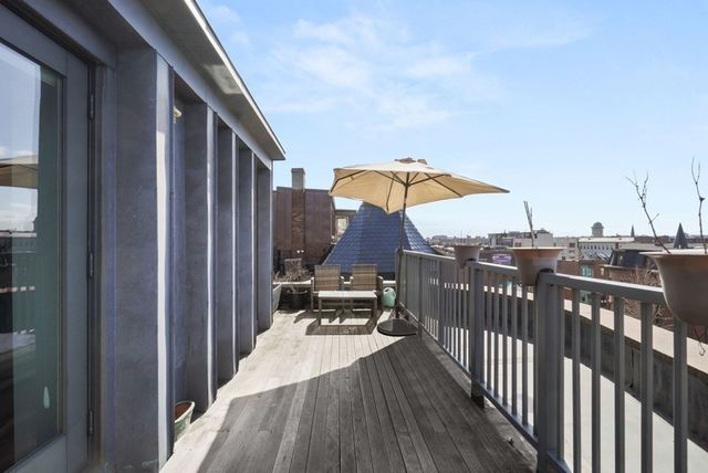 a view of a balcony with chairs