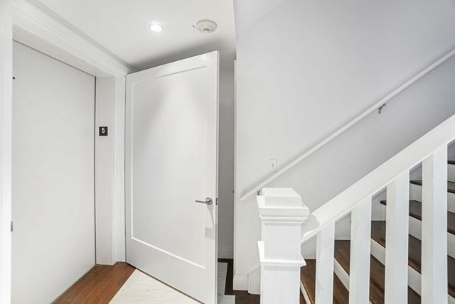 a view of staircase with white walls