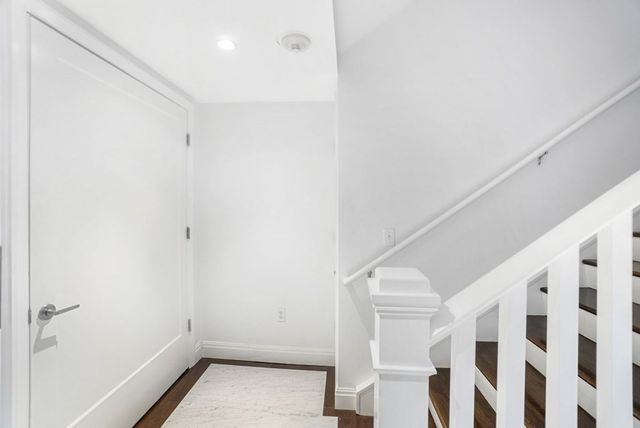 a view of room with stairs and white walls