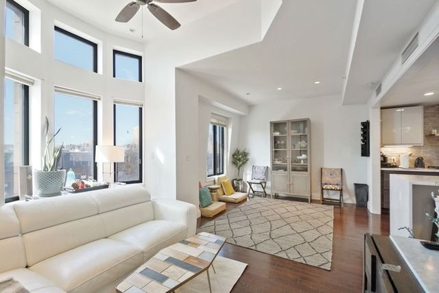 a living room with furniture wooden floor and a view of kitchen
