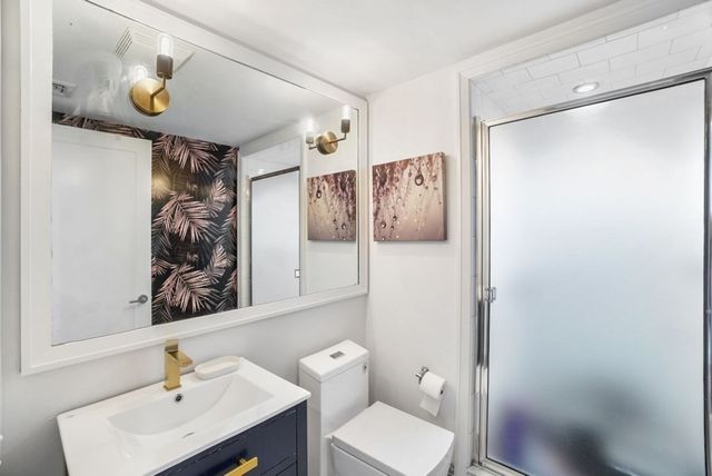 a bathroom with a sink toilet and shower