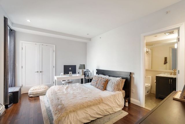 a bedroom with a bed and a flat tv screen