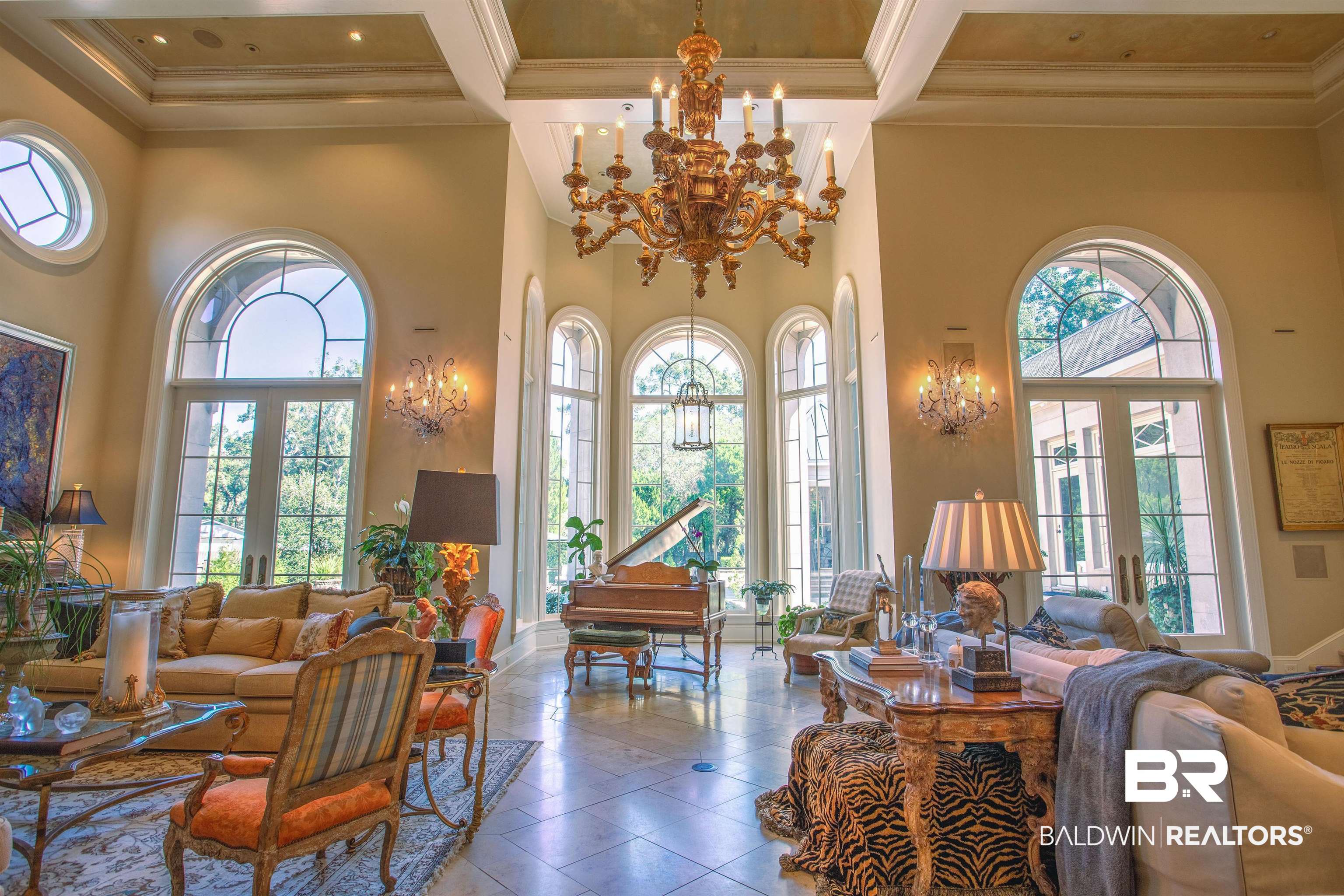 150 Austill Avenue Mobile, AL 36608 - Photo 8 of 39 Grand living area featuring soaring ceilings with intricate crown molding and a multi-tiered chandelier