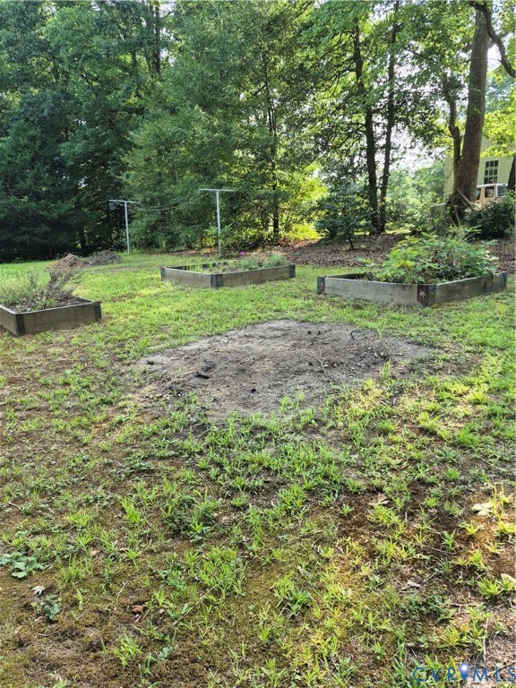 15731 Cooks Mill Road Lanexa, VA 23089 - Photo 2 of 14 Backyard featuring three raised garden beds, a clo