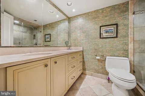 a spacious bathroom with a toilet sink and mirror