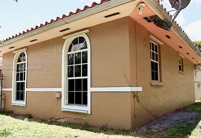 601 Northwest 97th Street, Unit 601 Miami, FL 33150 - Photo 12 of 14 a front view of a house with a yard