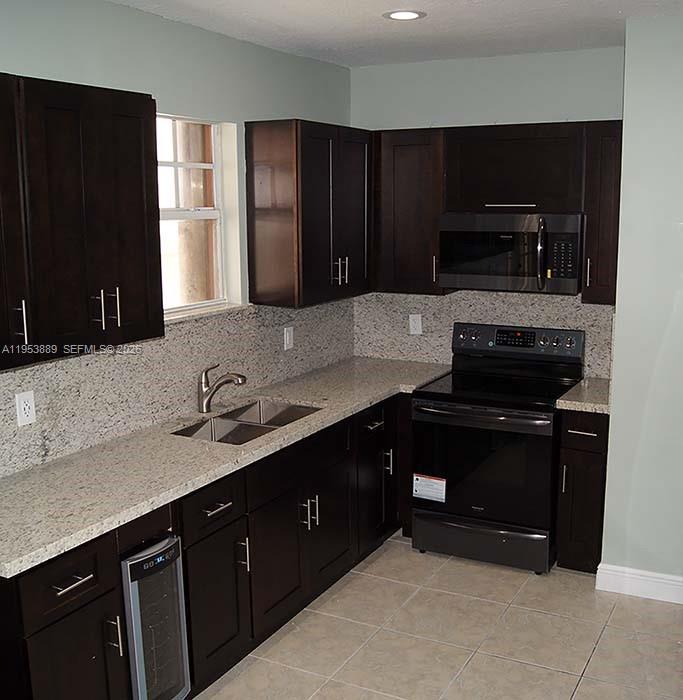 601 Northwest 97th Street, Unit 601 Miami, FL 33150 - Photo 2 of 14 a kitchen with a sink and a stove