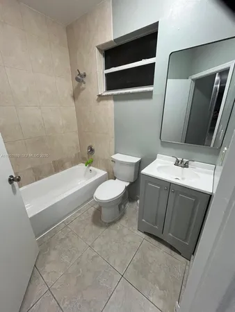 a bathroom with a sink a toilet and bathtub
