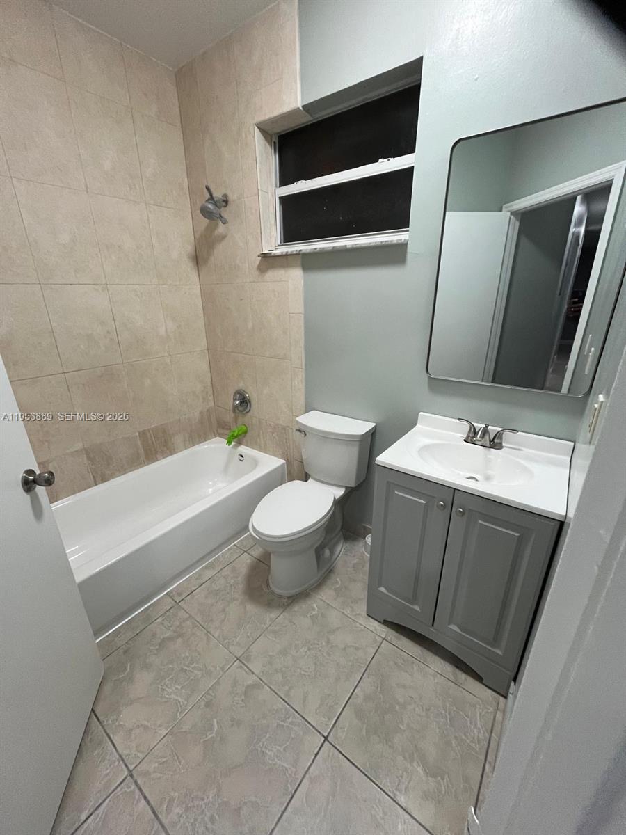 601 Northwest 97th Street, Unit 601 Miami, FL 33150 - Photo 8 of 14 a bathroom with a sink a toilet and bathtub