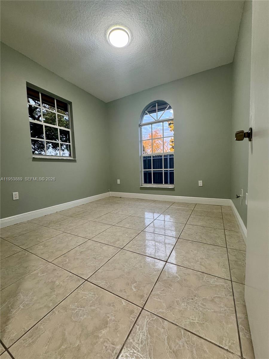 601 Northwest 97th Street, Unit 601 Miami, FL 33150 - Photo 10 of 16 a view of an empty room with a window