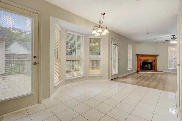 an empty room with fireplace and windows