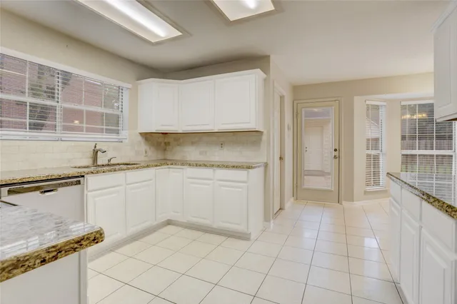 a kitchen with granite countertop a sink and a stove