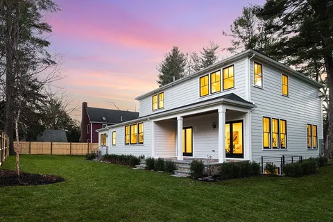 a front view of a house with a garden and plants