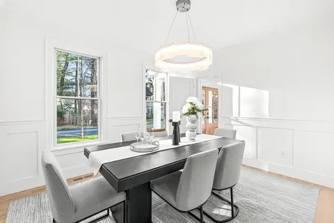 a dining room with furniture and window