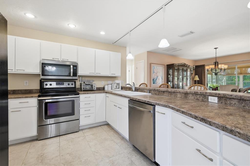 1802 69th Street West Bradenton, FL 34209 - Photo 14 of 31 a kitchen with sink a microwave and cabinets