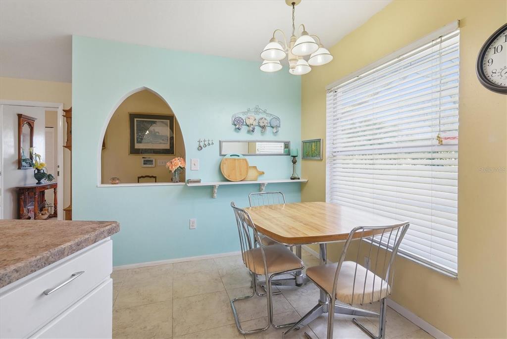 1802 69th Street West Bradenton, FL 34209 - Photo 16 of 31 a view of a dining room with furniture and chandelier