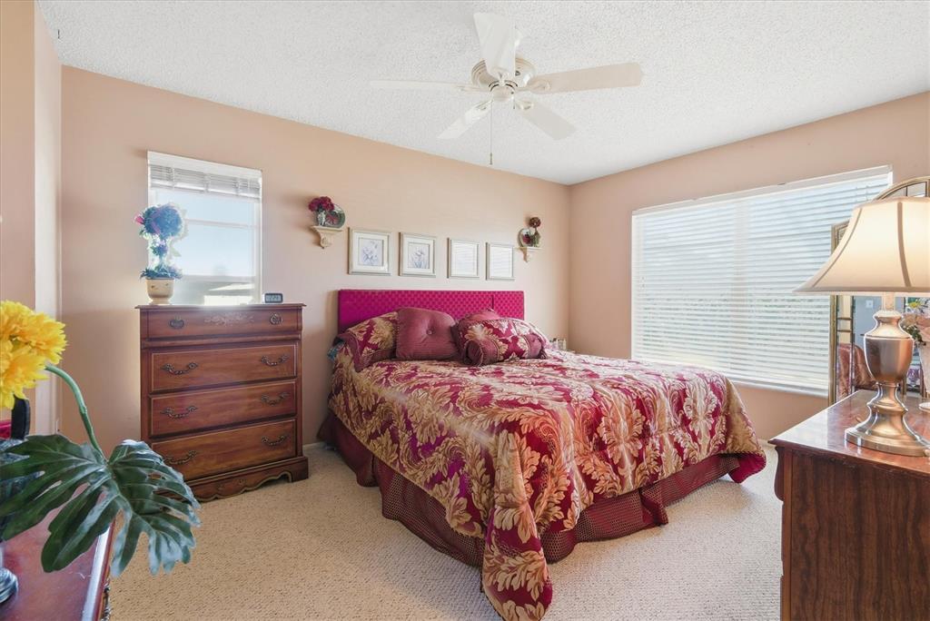 1802 69th Street West Bradenton, FL 34209 - Photo 17 of 31 a bedroom with a bed and a chandelier