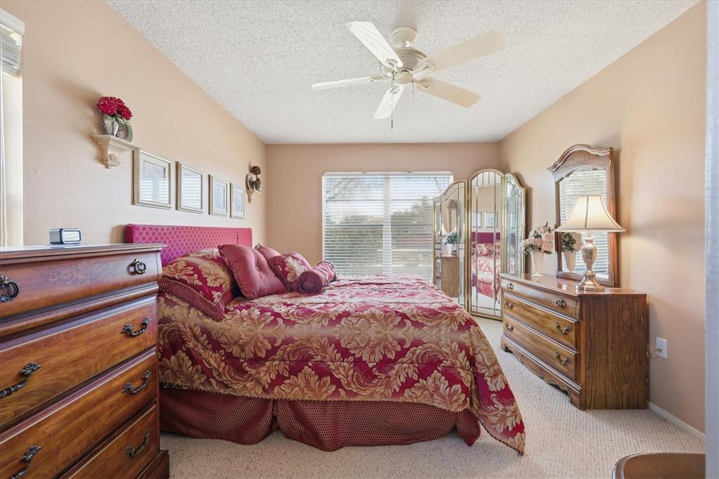 1802 69th Street West Bradenton, FL 34209 - Photo 19 of 31 a bedroom with a bed and dresser with mirror