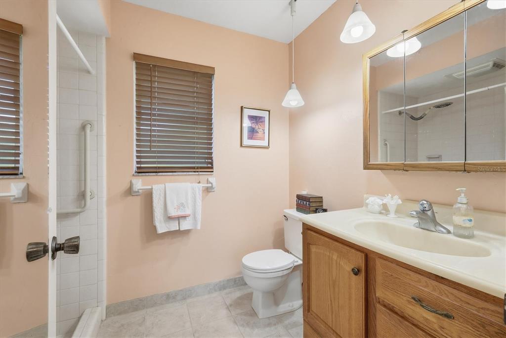 1802 69th Street West Bradenton, FL 34209 - Photo 22 of 31 a bathroom with a sink a toilet and shower