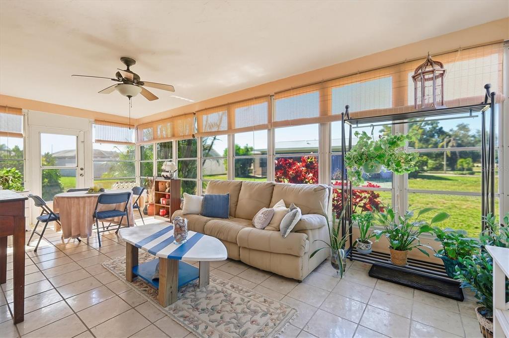 1802 69th Street West Bradenton, FL 34209 - Photo 24 of 31 a living room with patio furniture and a potted plants