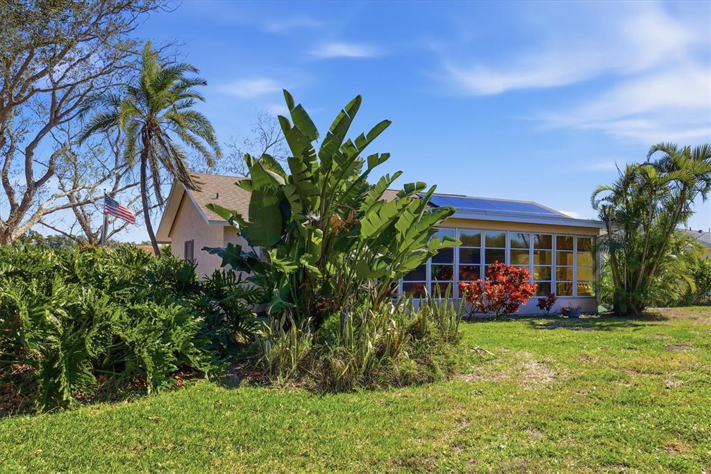 1802 69th Street West Bradenton, FL 34209 - Photo 30 of 31 a view of a white house with a big yard and potted plants
