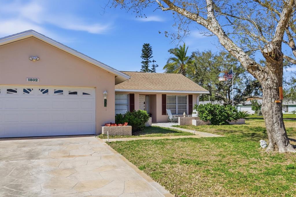 1802 69th Street West Bradenton, FL 34209 - Photo 3 of 31 a front view of a house with garden