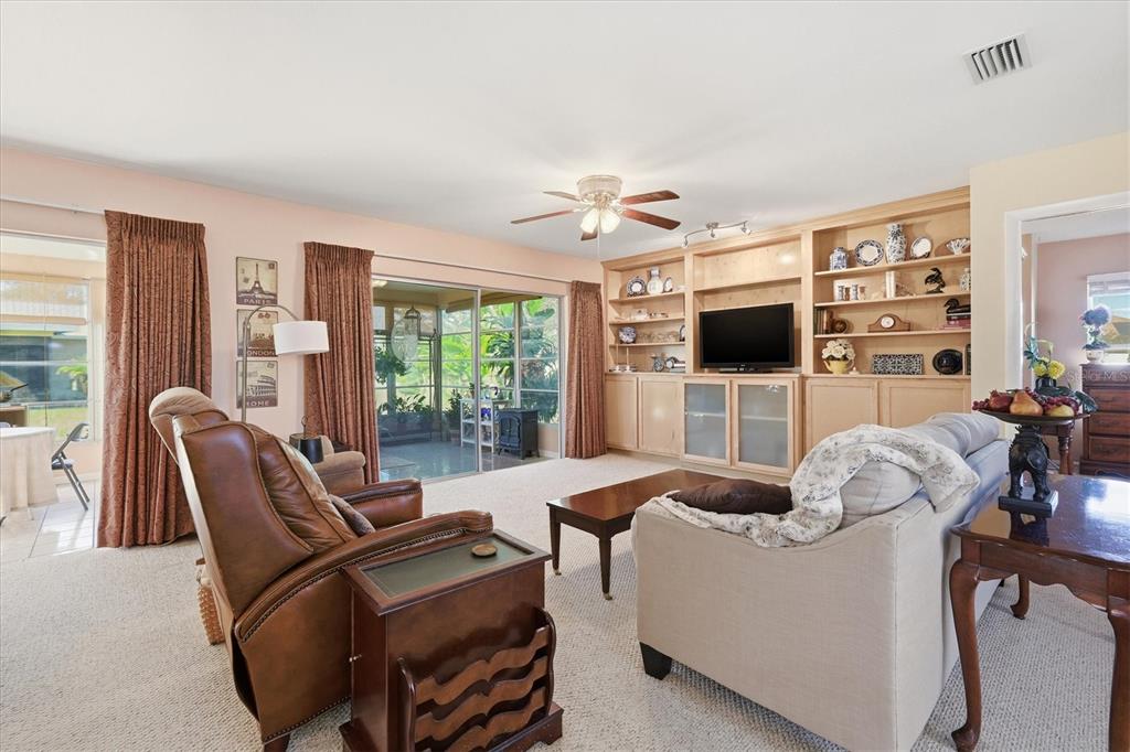 1802 69th Street West Bradenton, FL 34209 - Photo 6 of 31 a living room with furniture a flat screen tv and a fireplace