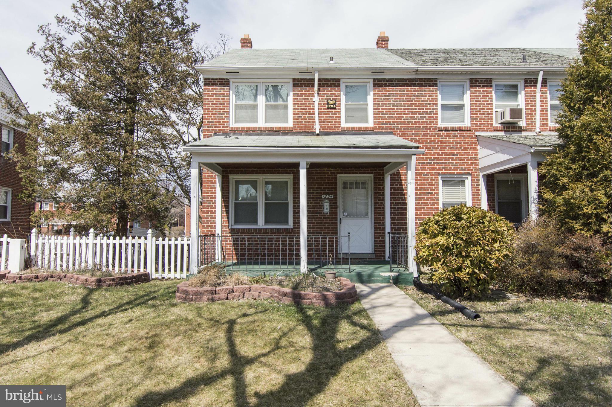 1254 Cedarcroft Road Baltimore, MD 21239 - Photo 1 of 30 a front view of a house with garden
