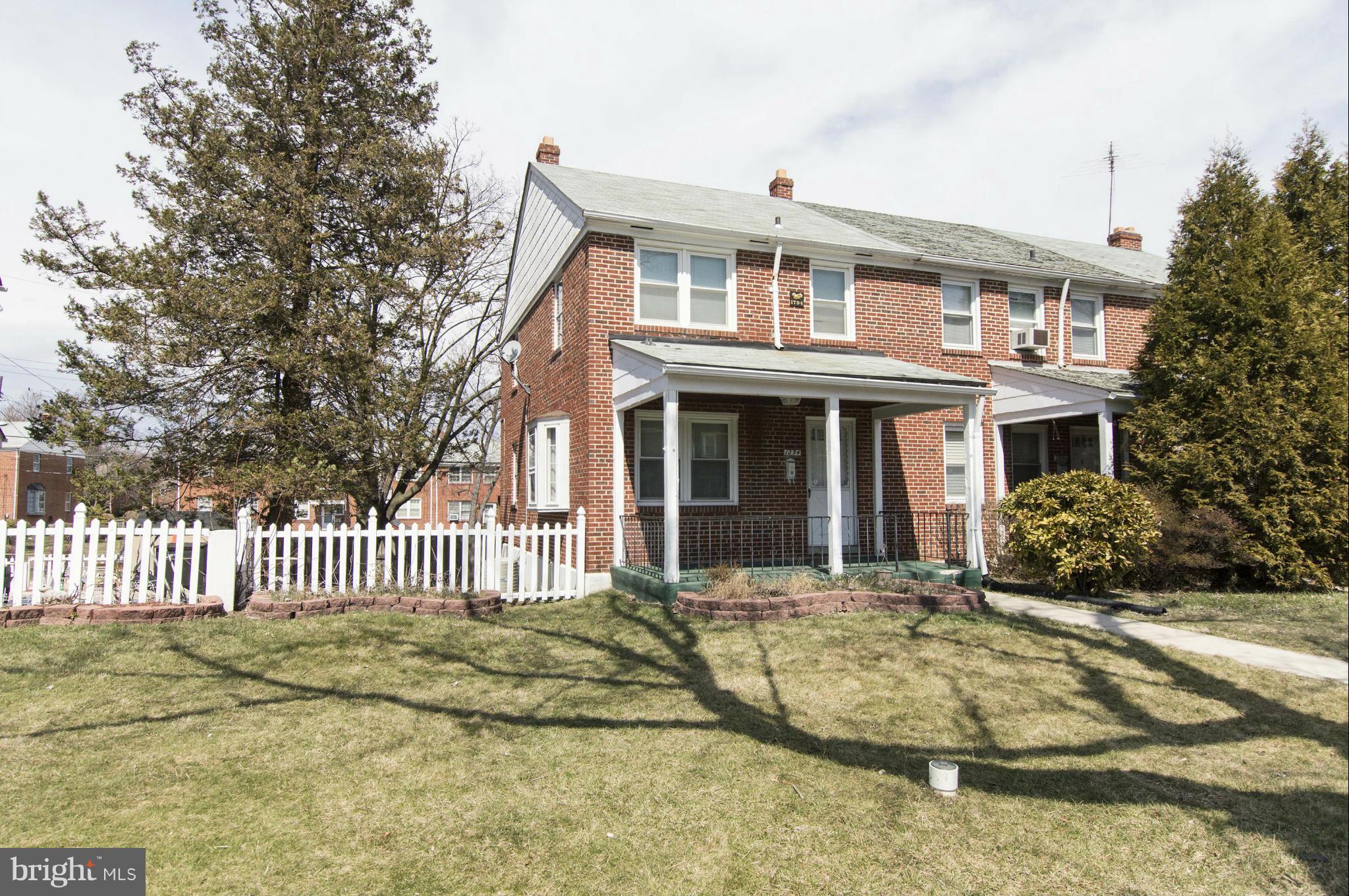 1254 Cedarcroft Road Baltimore, MD 21239 - Photo 2 of 30 a front view of a house with a garden