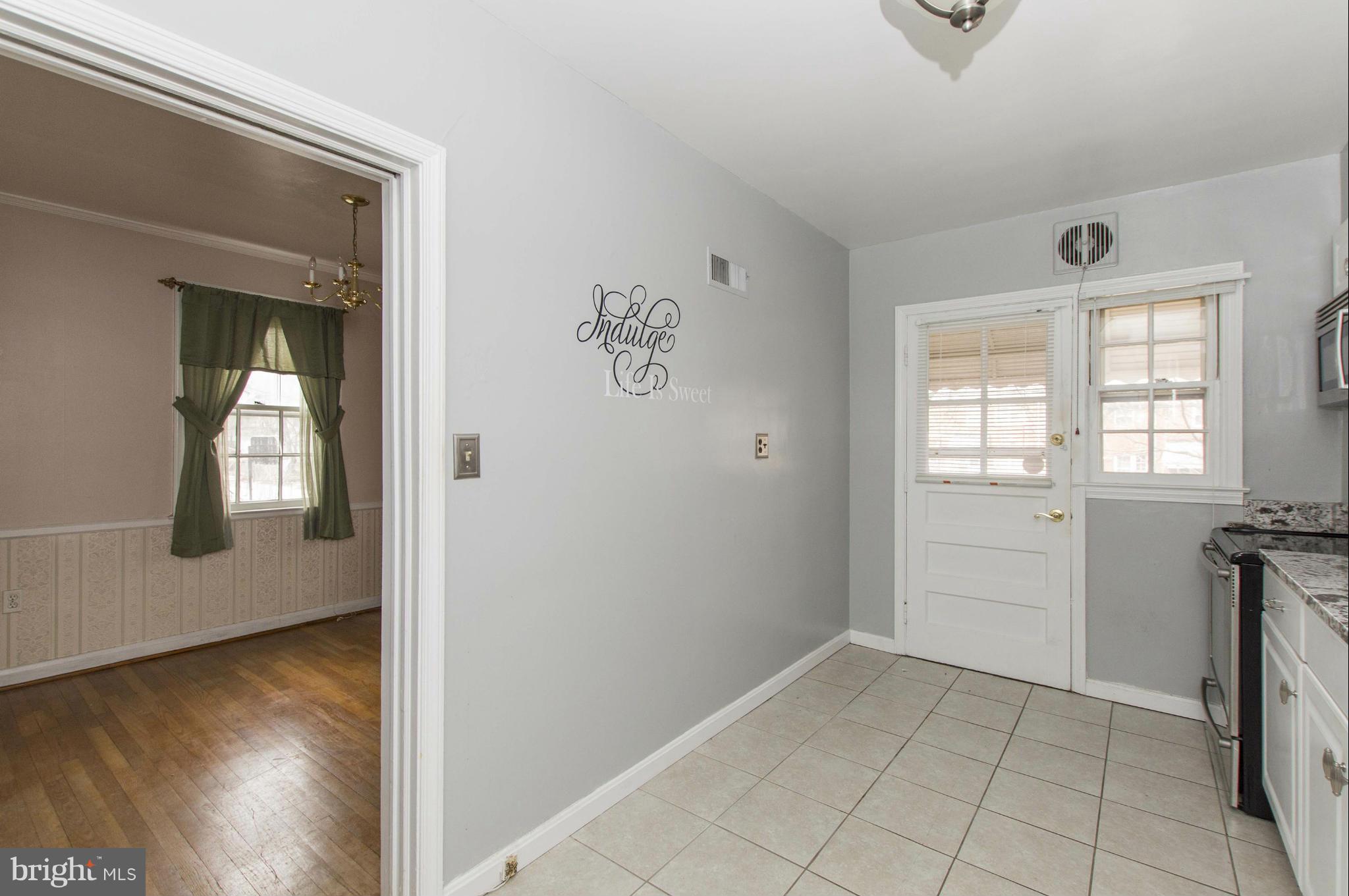 1254 Cedarcroft Road Baltimore, MD 21239 - Photo 12 of 30 wooden floor in an empty room and a window