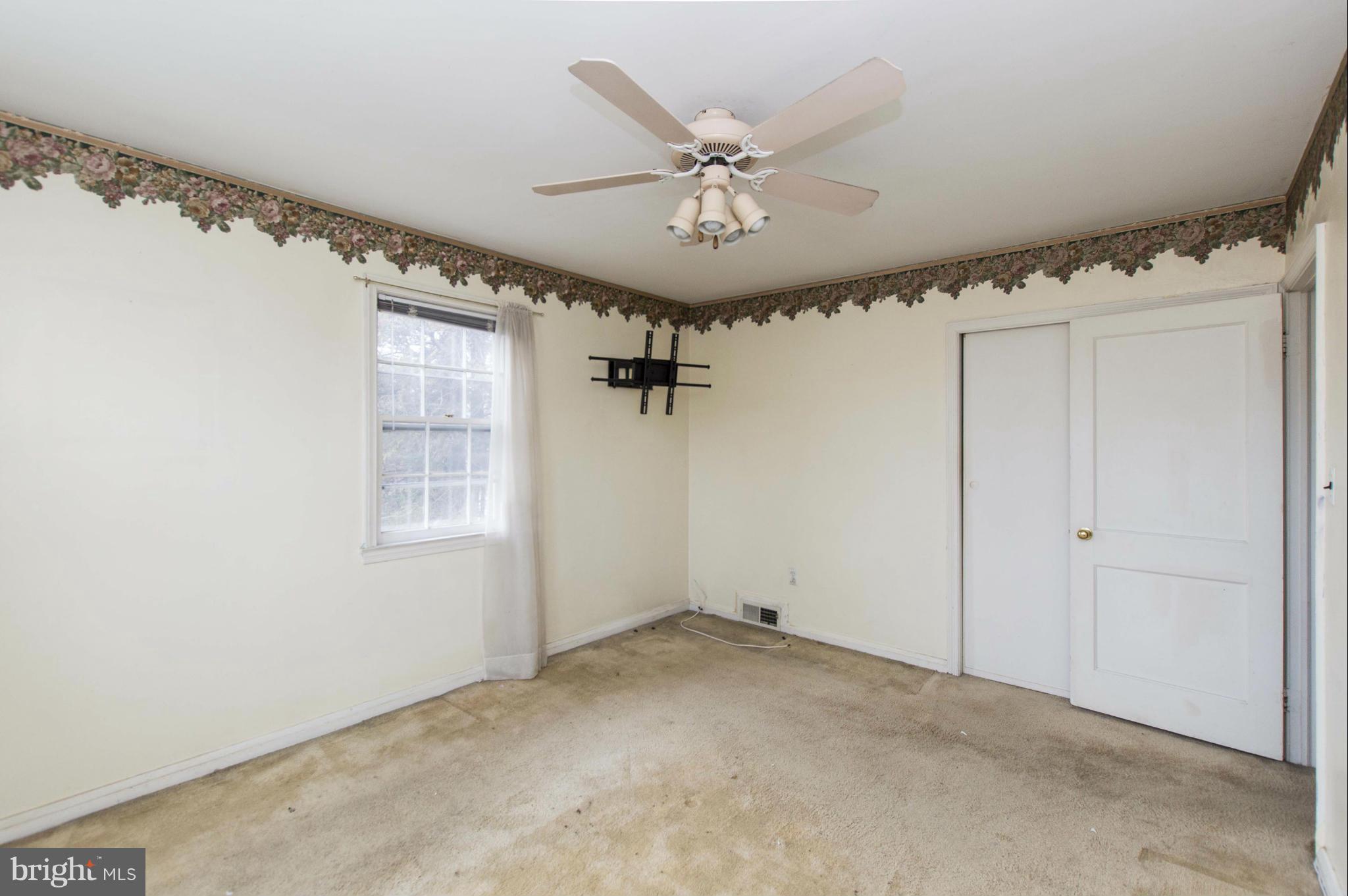 1254 Cedarcroft Road Baltimore, MD 21239 - Photo 15 of 30 an empty room with windows and fan