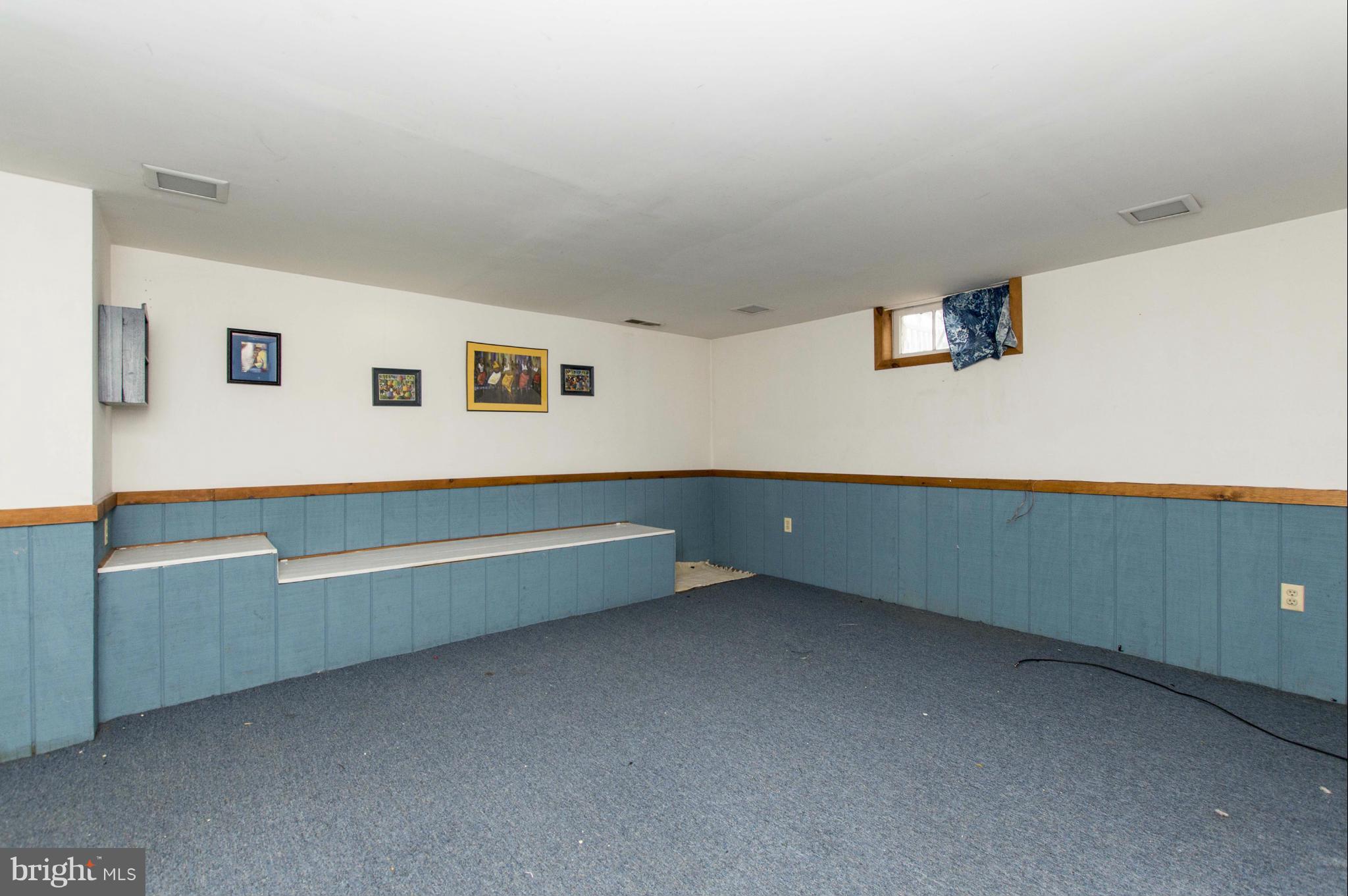 1254 Cedarcroft Road Baltimore, MD 21239 - Photo 22 of 30 a room with lounge chair and the view of living room