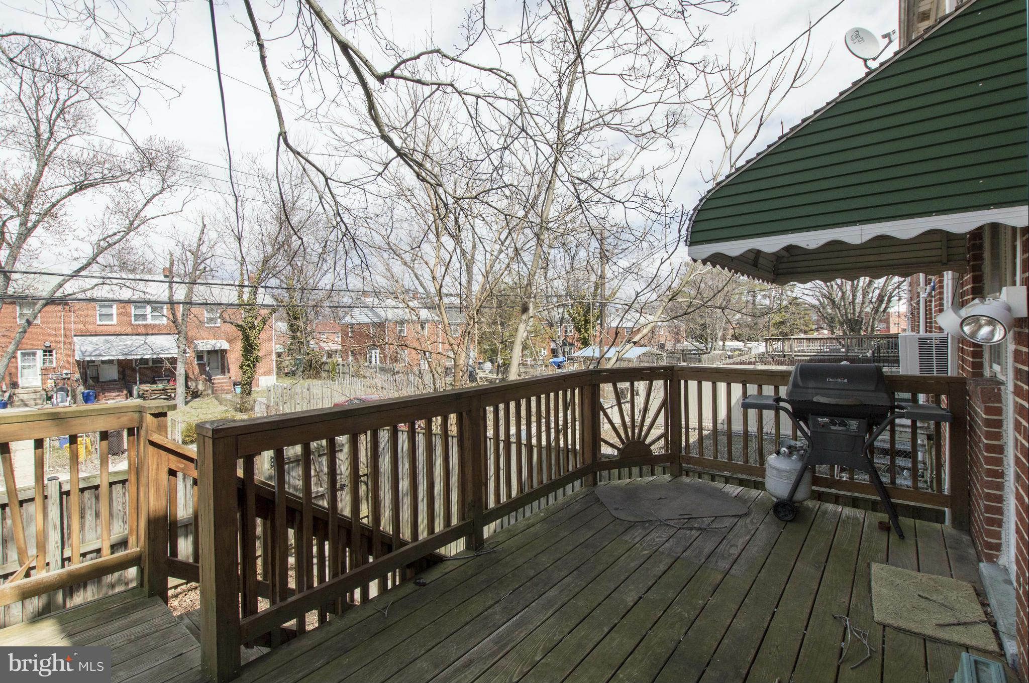 1254 Cedarcroft Road Baltimore, MD 21239 - Photo 26 of 30 a view of balcony with wooden floor and outdoor seating