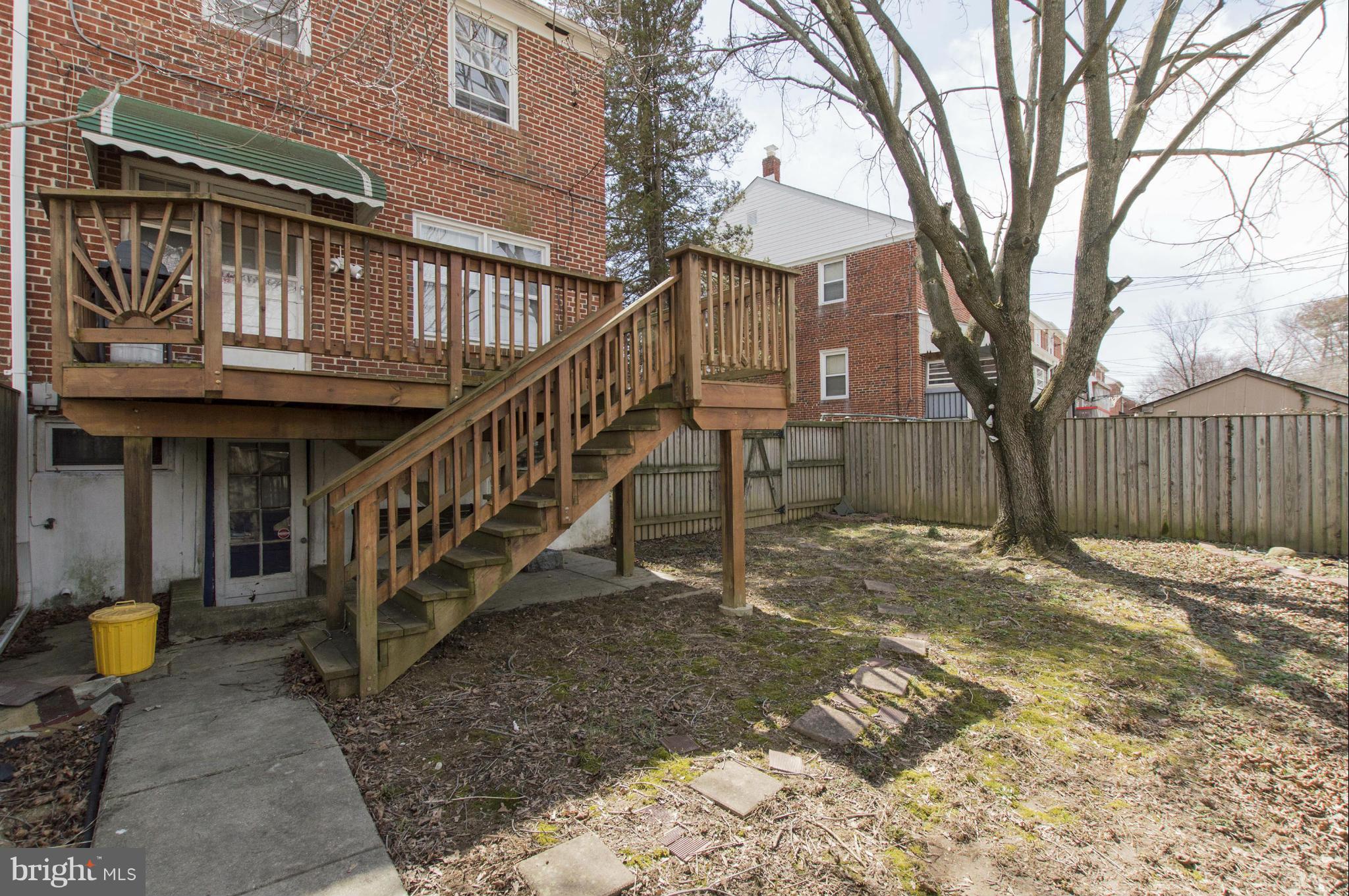 1254 Cedarcroft Road Baltimore, MD 21239 - Photo 27 of 30 a view of a house with wooden stairs and a small yard