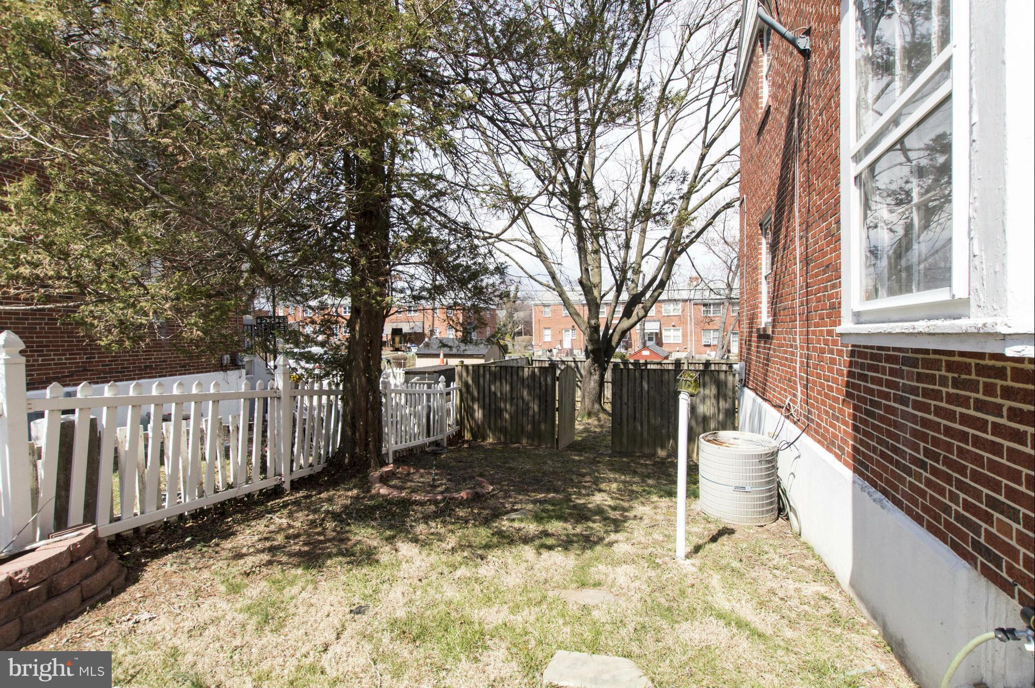 1254 Cedarcroft Road Baltimore, MD 21239 - Photo 29 of 30 a view of a yard with wooden fence and a bench