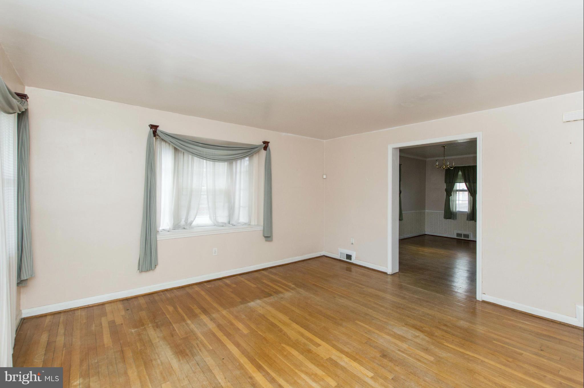 1254 Cedarcroft Road Baltimore, MD 21239 - Photo 4 of 30 a view of empty room with wooden floor and fan