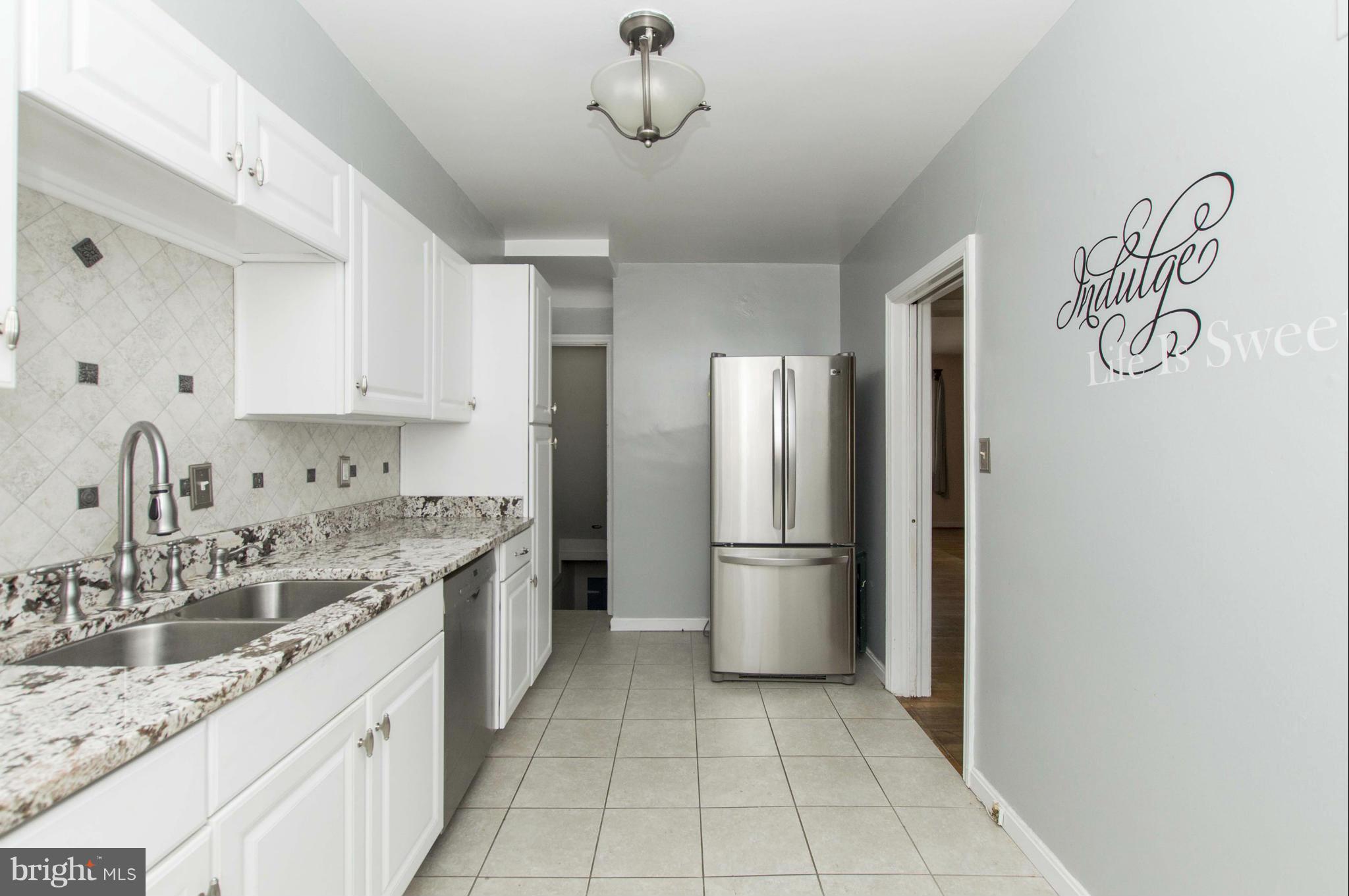 1254 Cedarcroft Road Baltimore, MD 21239 - Photo 10 of 30 a kitchen with a sink and refrigerator