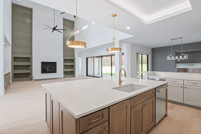 a living room with patio furniture and a large window