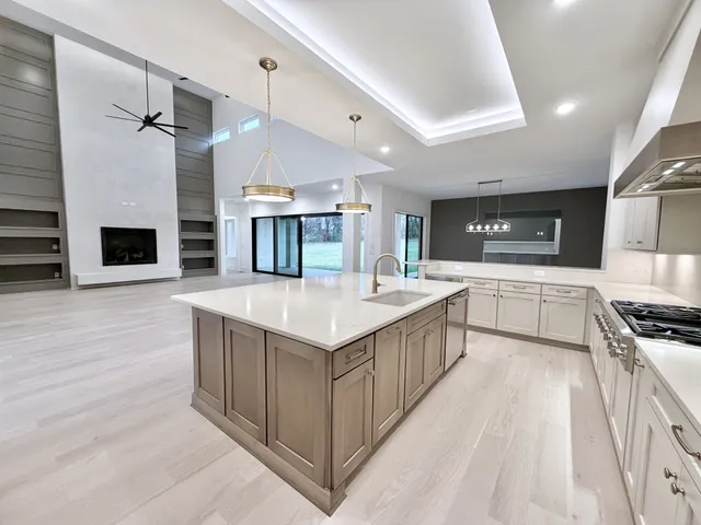 a kitchen with stainless steel appliances a sink stove and cabinets